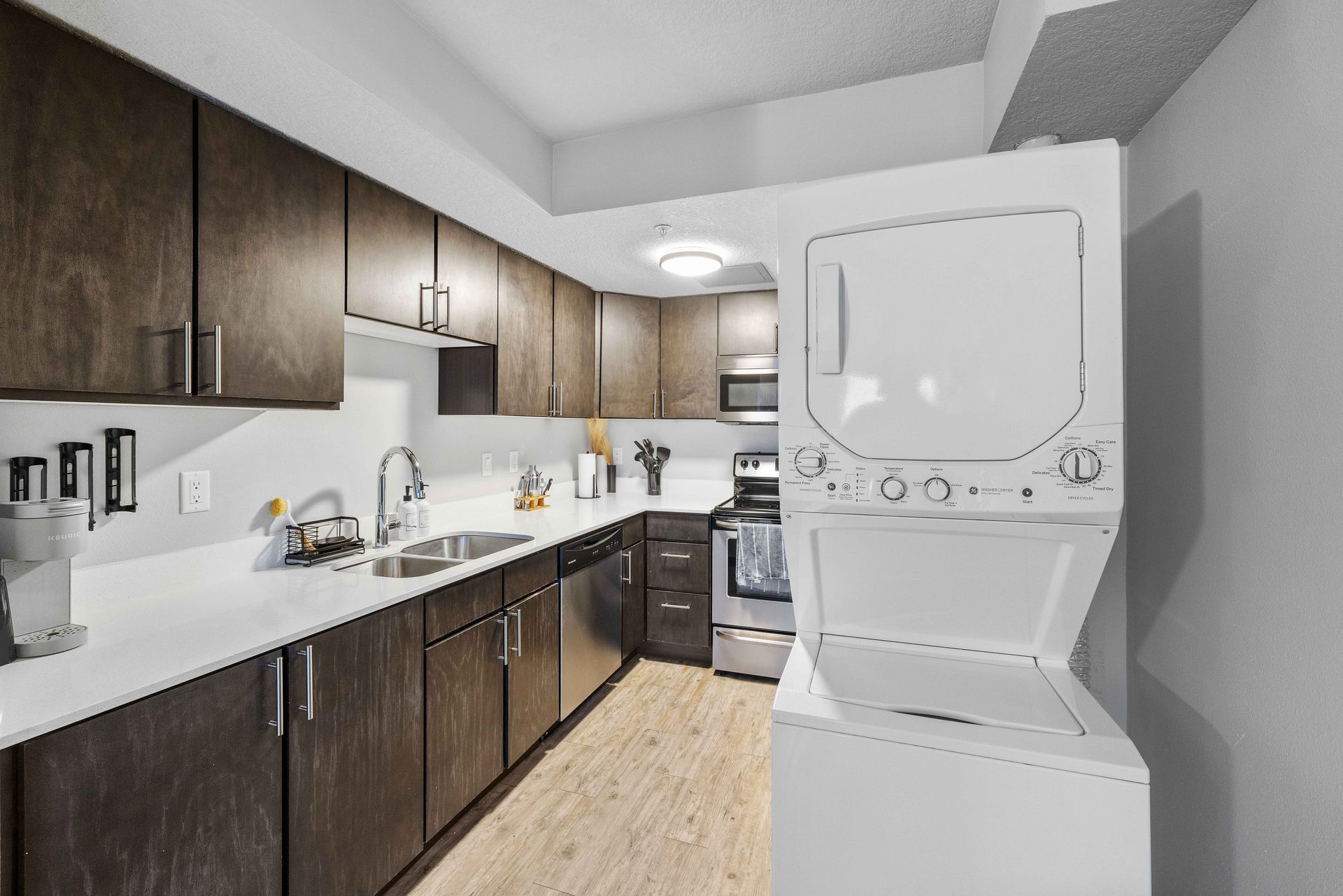 a kitchen with a washer and dryer stacked on top of each other .