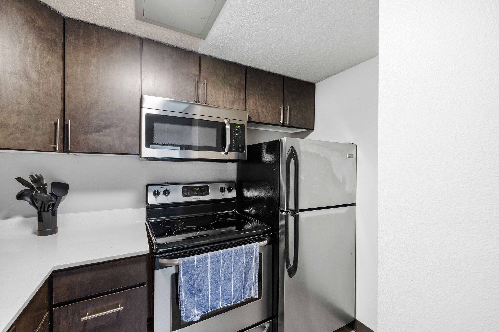 a kitchen with stainless steel appliances and wooden cabinets