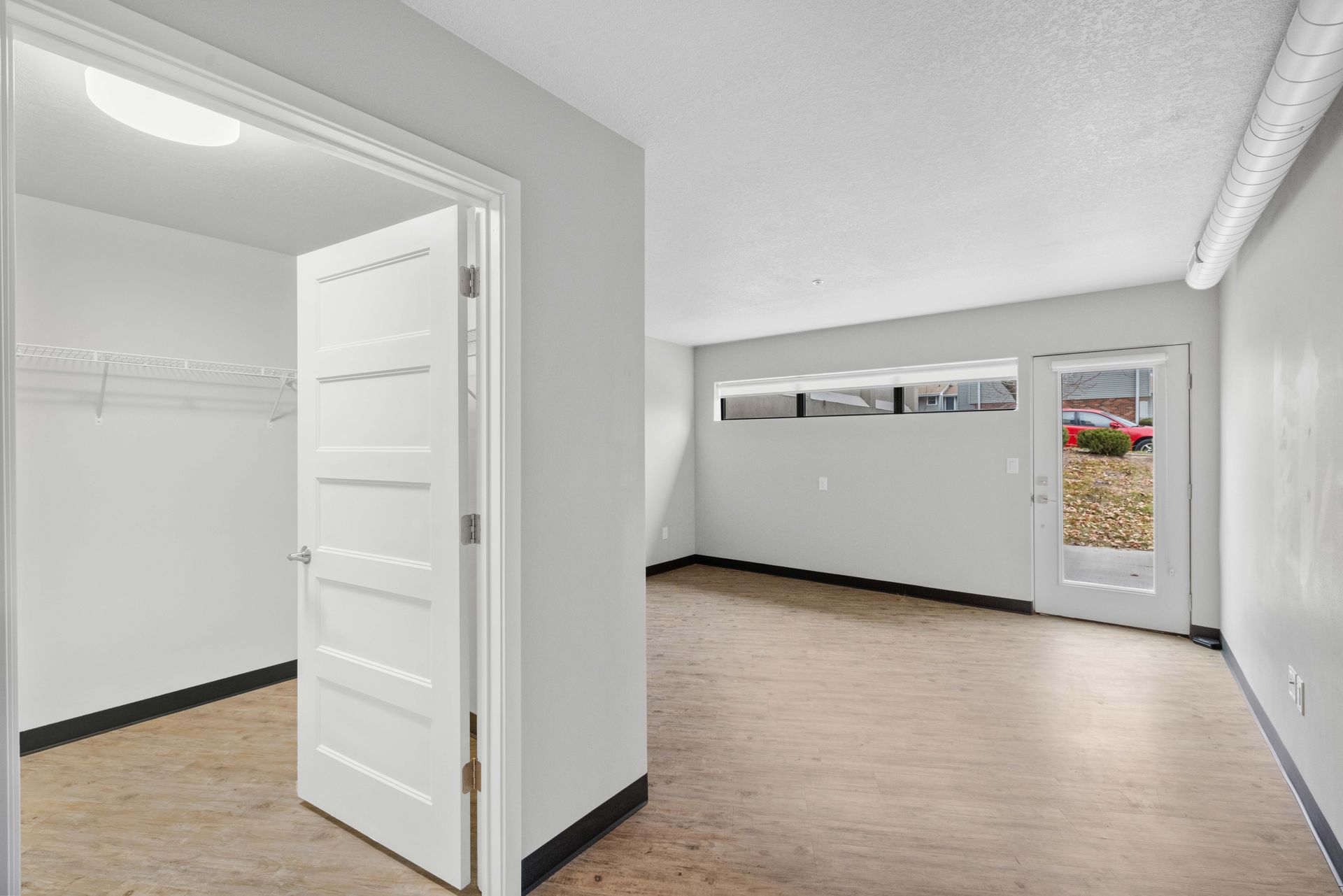 an empty room with a door open and a window .