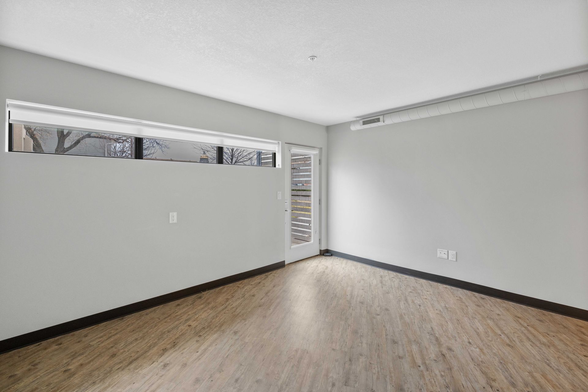 an empty room with a carpeted floor and white walls .