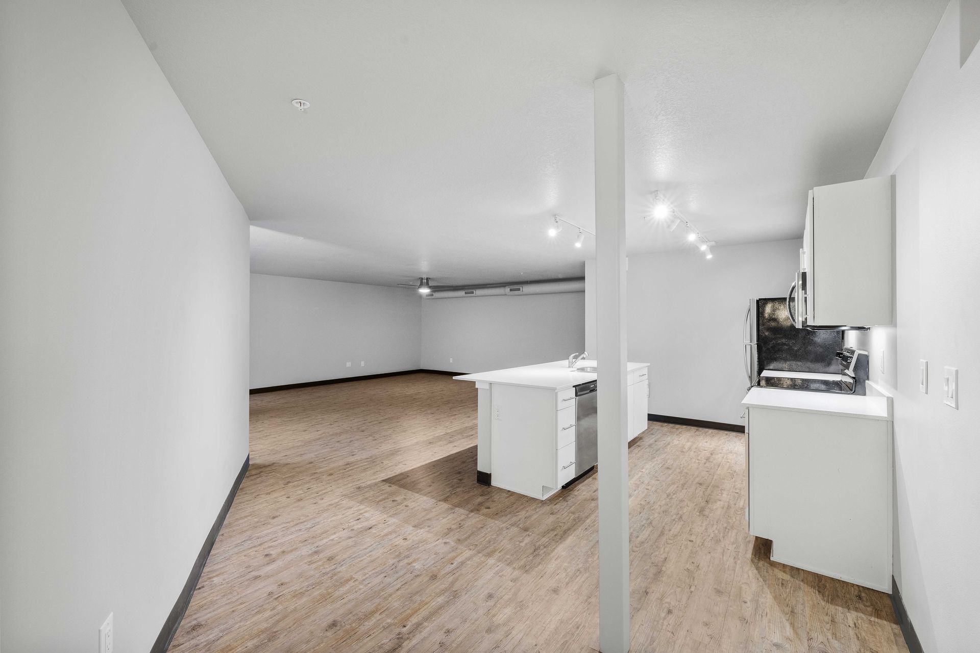 there is a kitchen in the corner of the room .