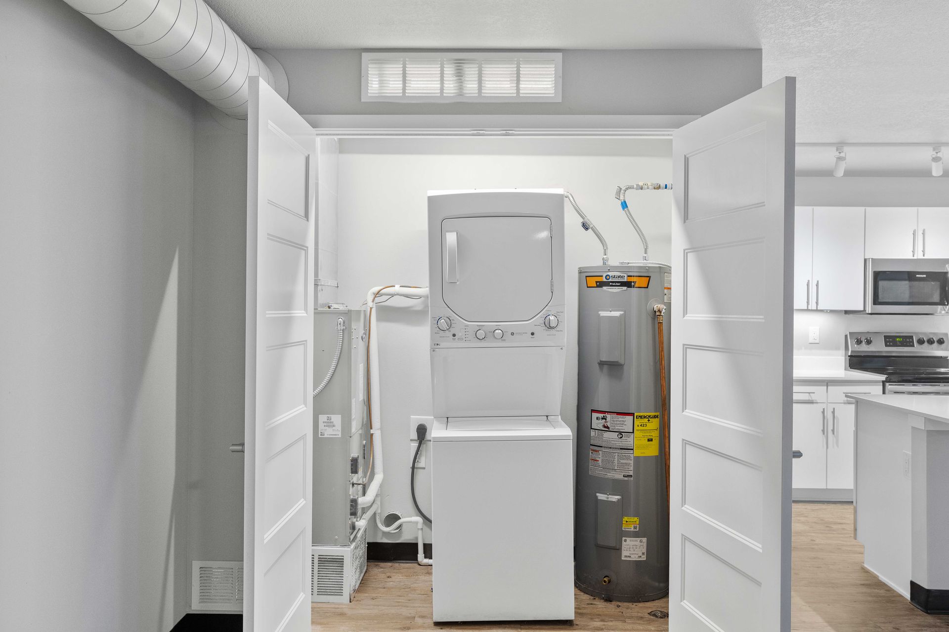 a laundry room with a washer and dryer stacked on top of each other .