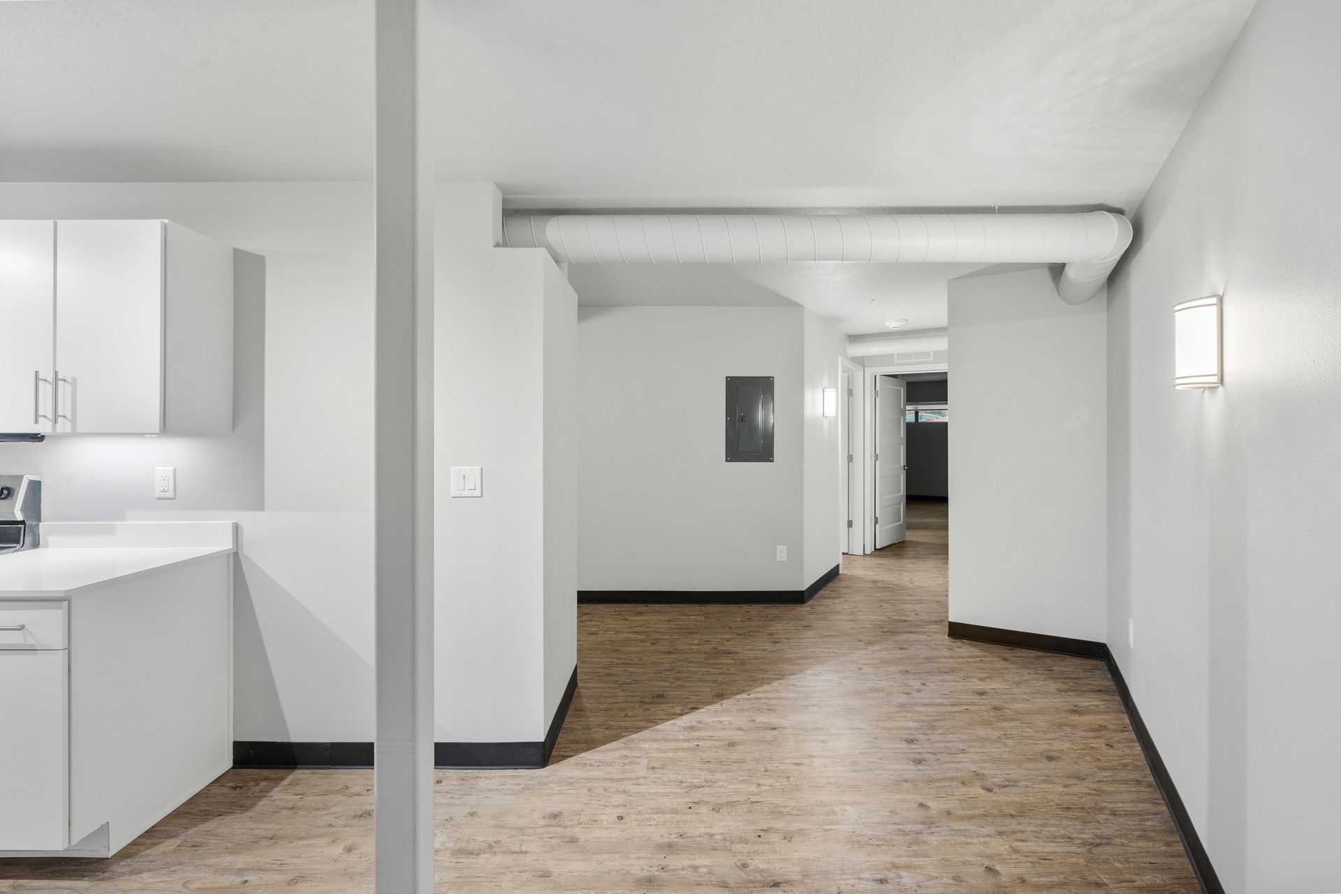 an empty room with white walls and wooden floors .