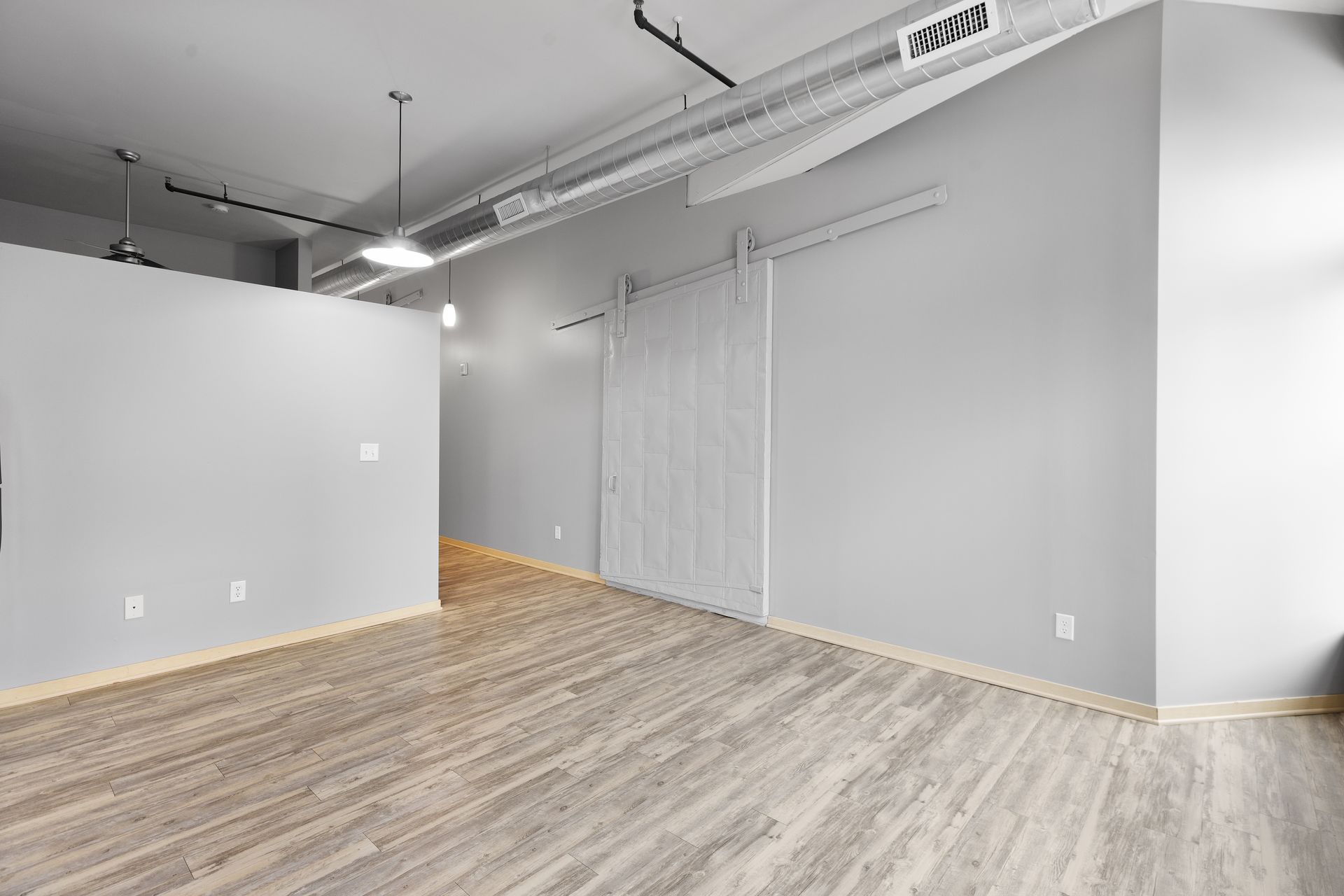there is a sliding barn door in the middle of the room .