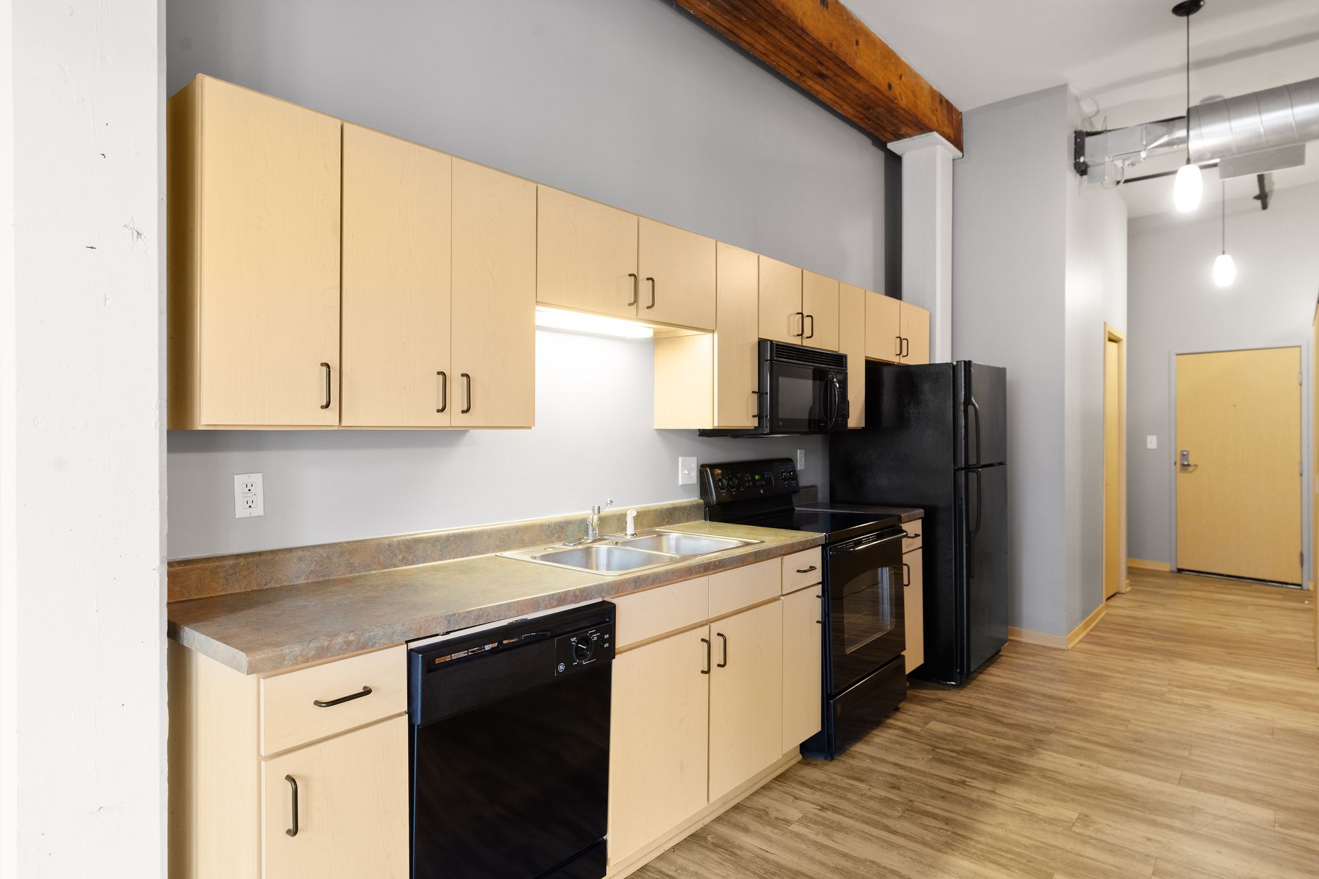 a kitchen with a sink , stove , refrigerator , microwave and dishwasher .