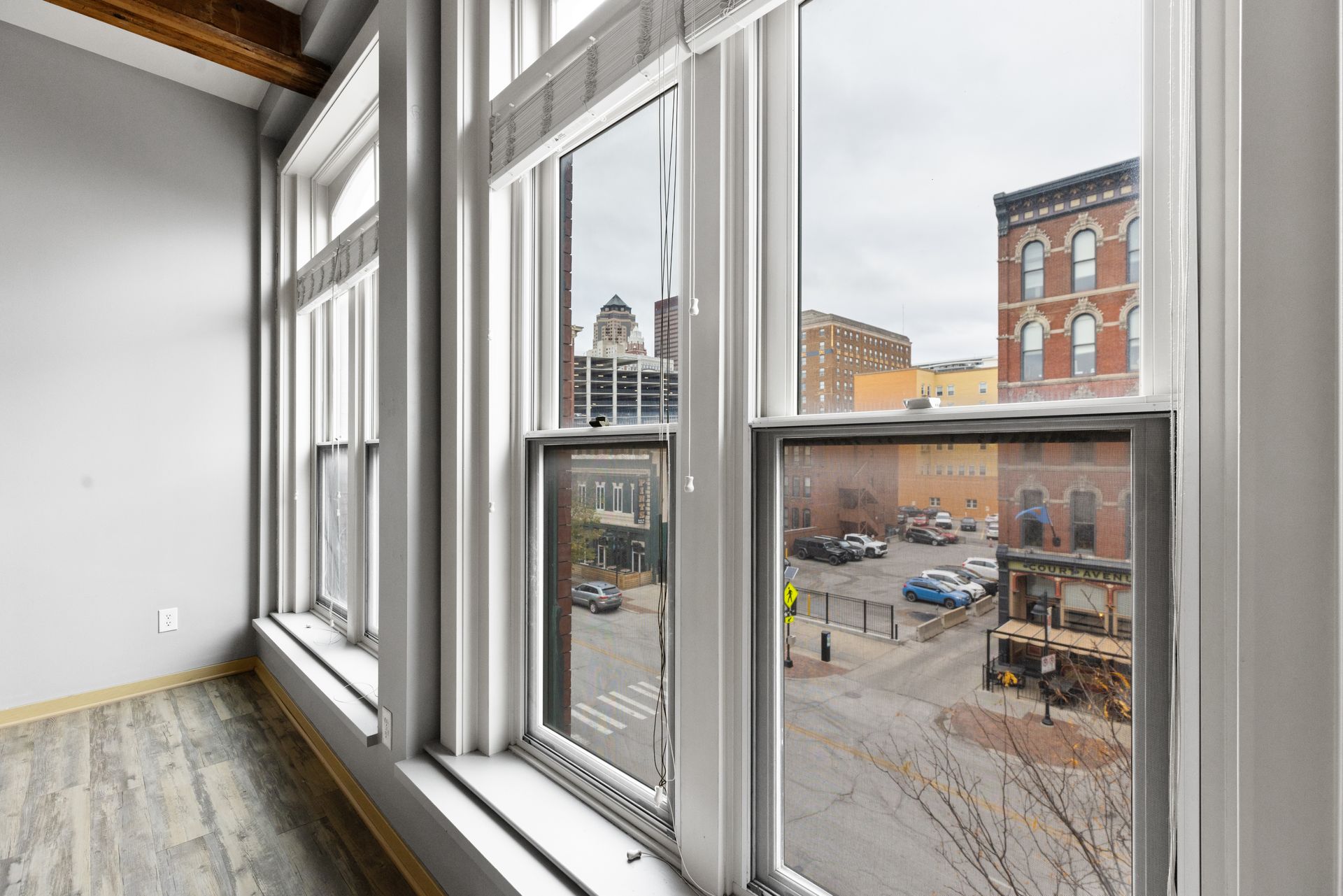 a room with a lot of windows and a view of a city .