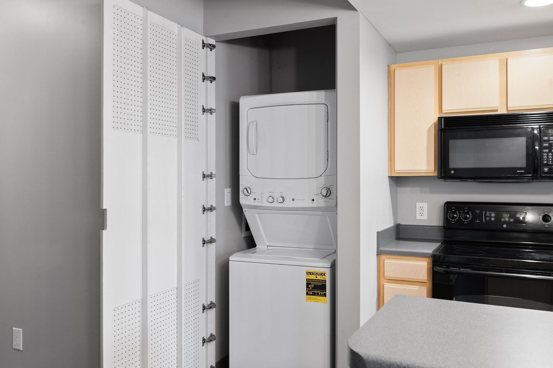 a washer and dryer are stacked on top of each other in a kitchen .