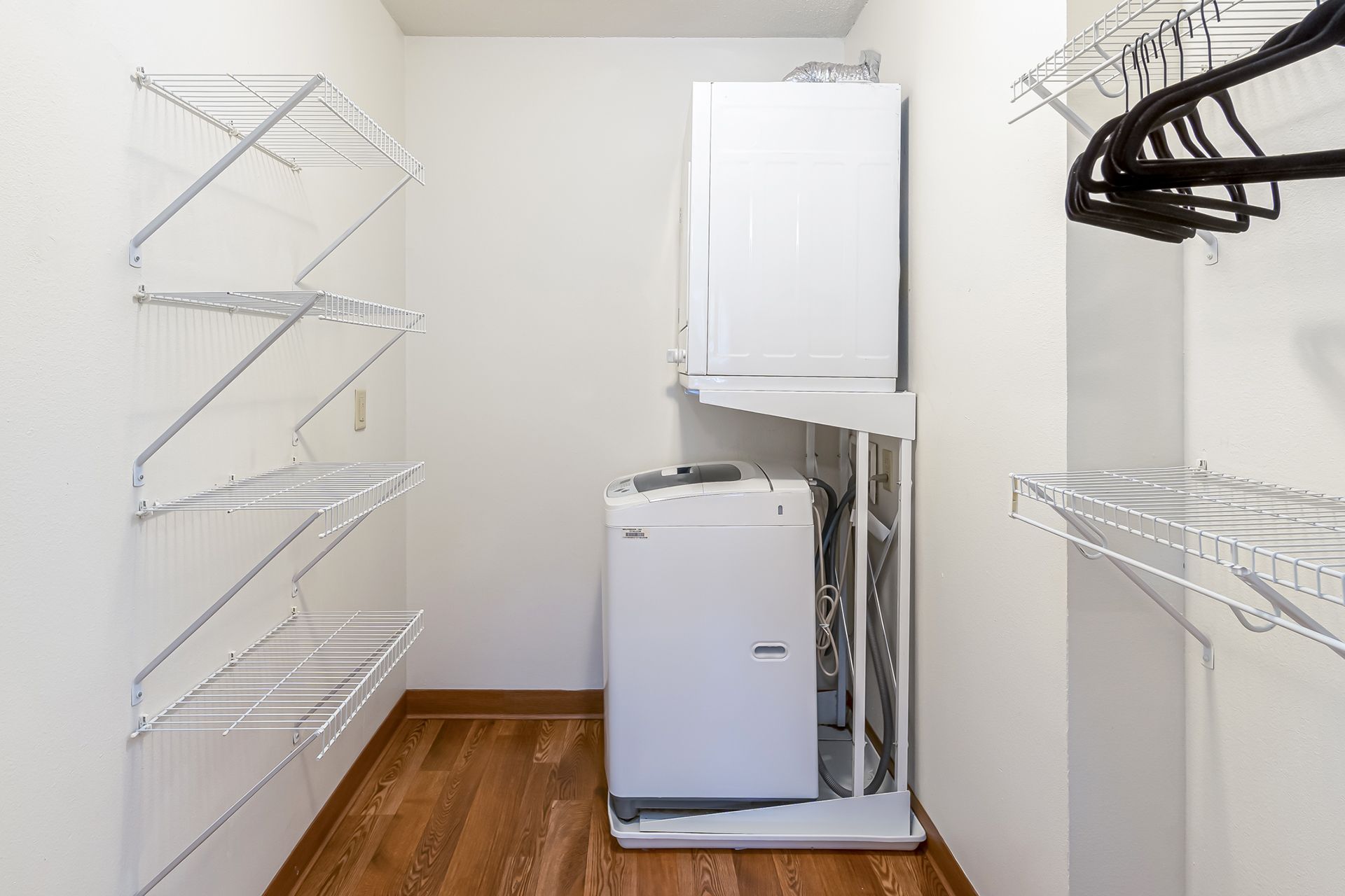 a laundry room with a washer and dryer stacked on top of each other .