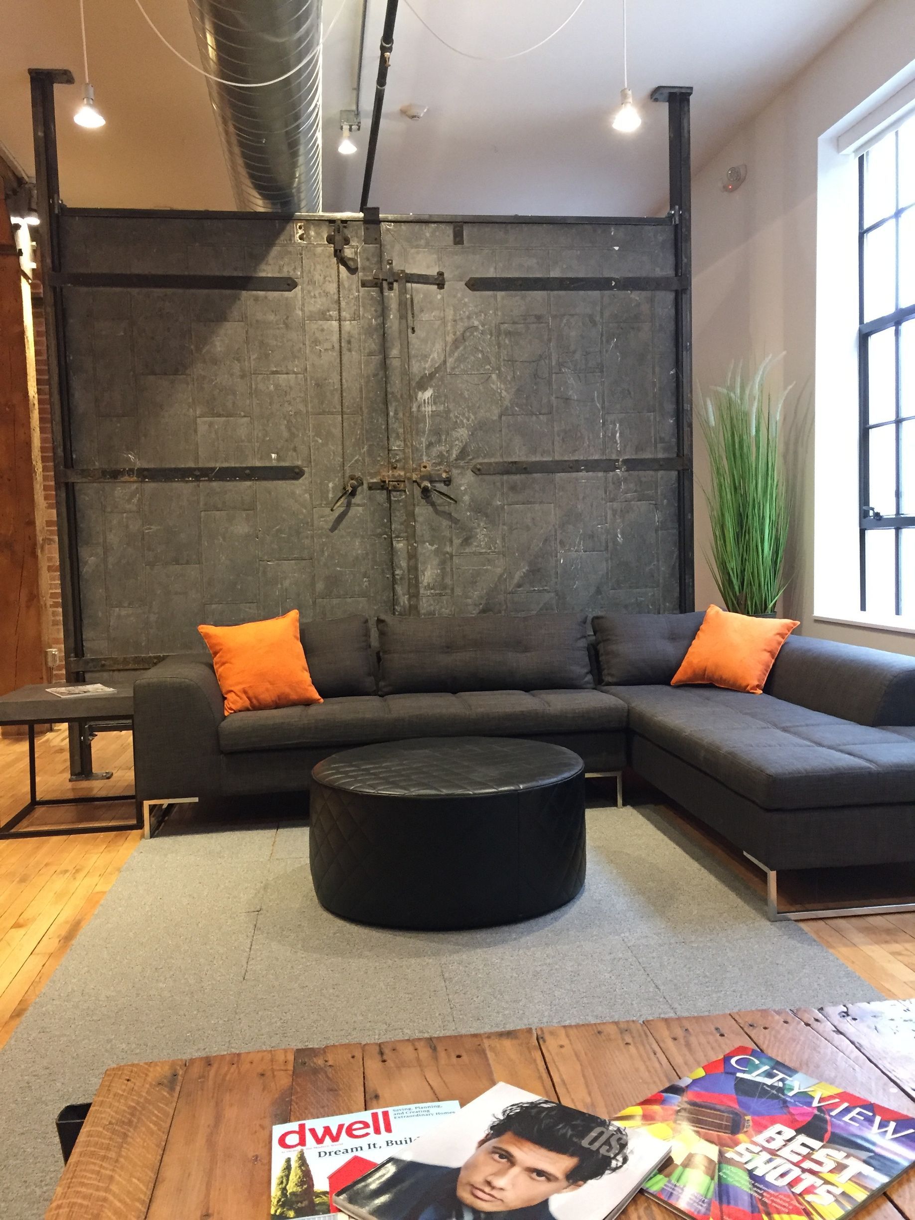 a living room with a couch and a table with magazines on it