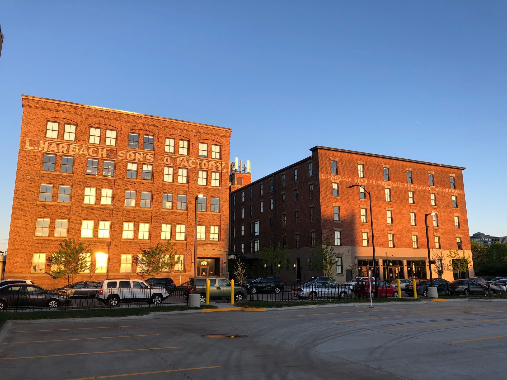 two large brick buildings with cars parked in front of them