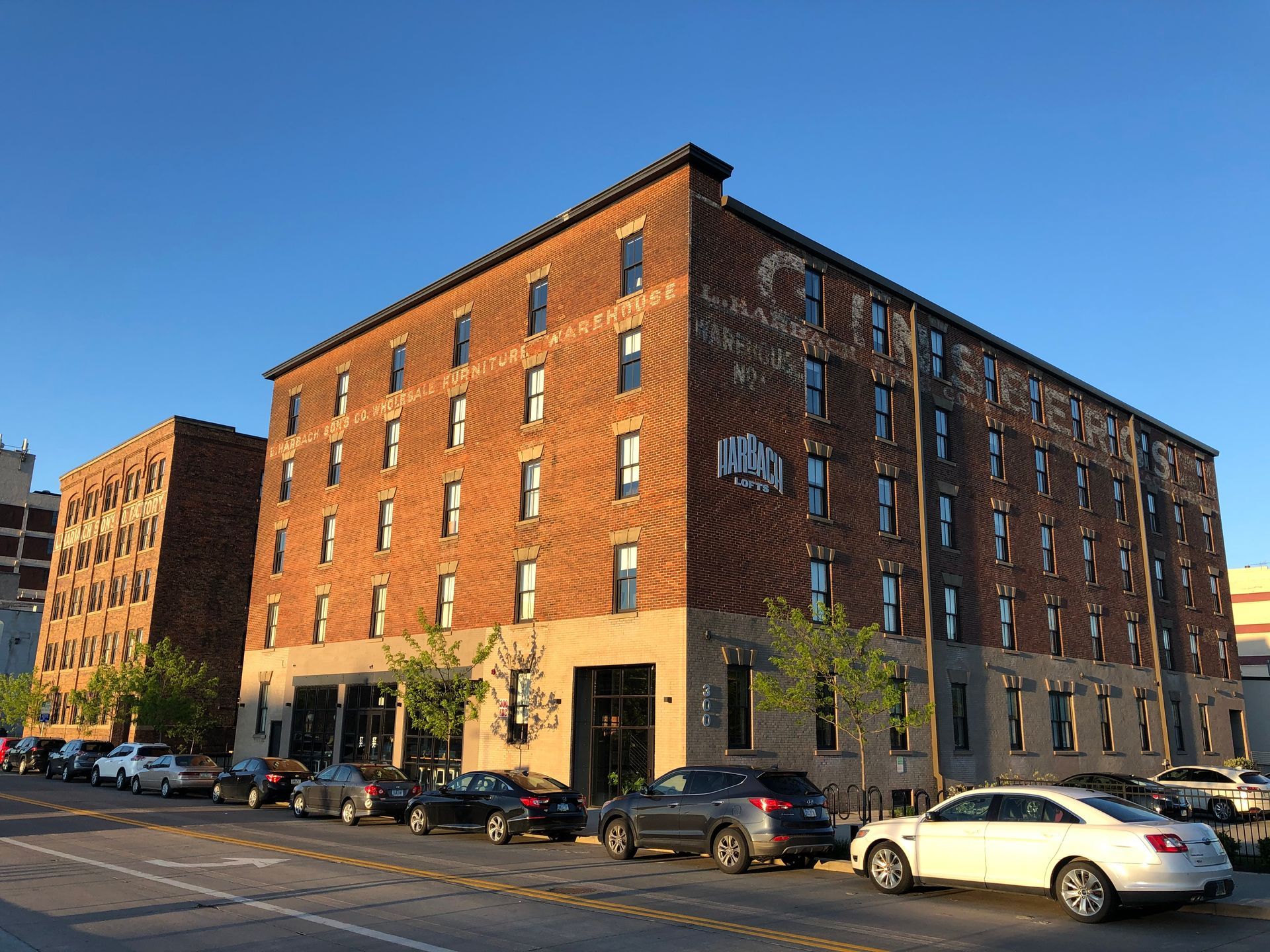 a large brick building with cars parked in front of it .