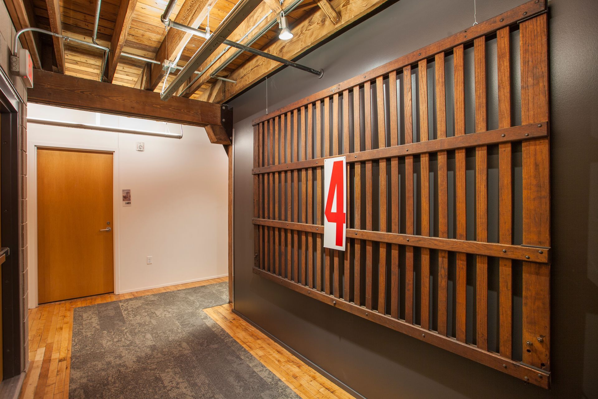 a hallway with a wooden fence and a sign that says 4