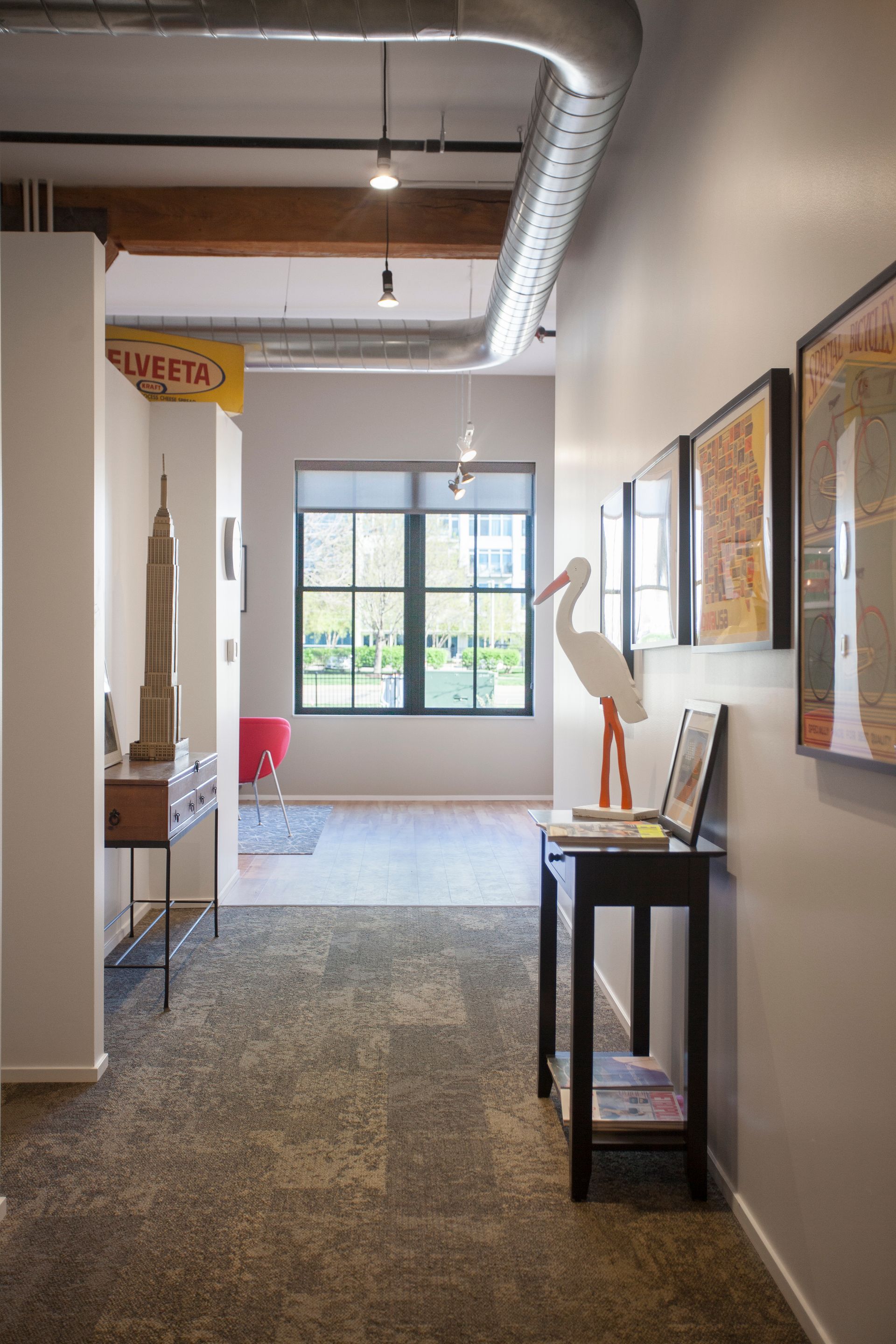 a hallway with a statue of a stork on a table .