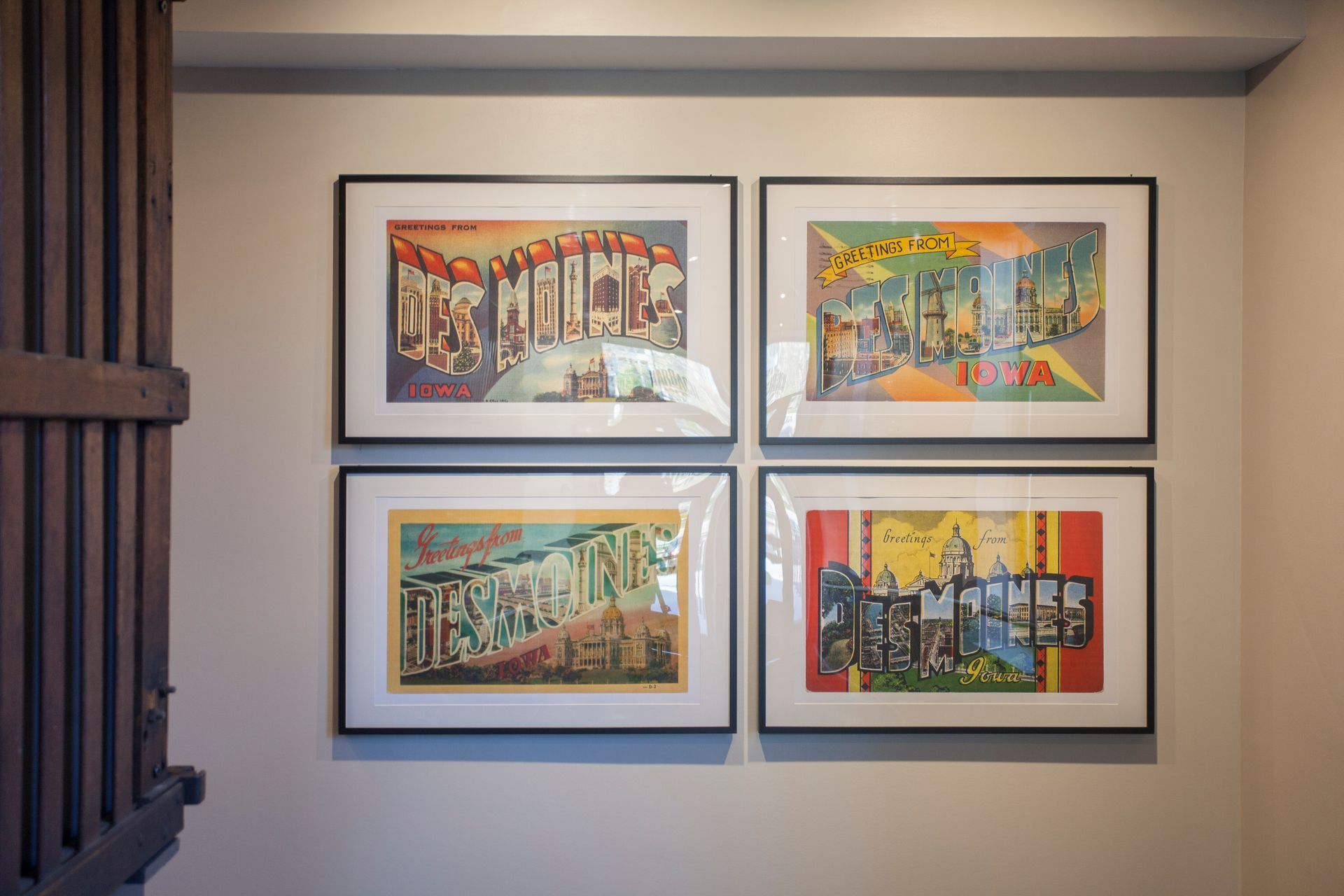 four framed pictures are hanging on a wall .