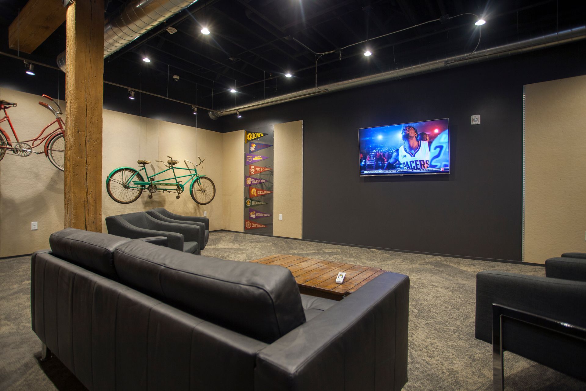 a living room with a couch , chairs , and a flat screen tv .