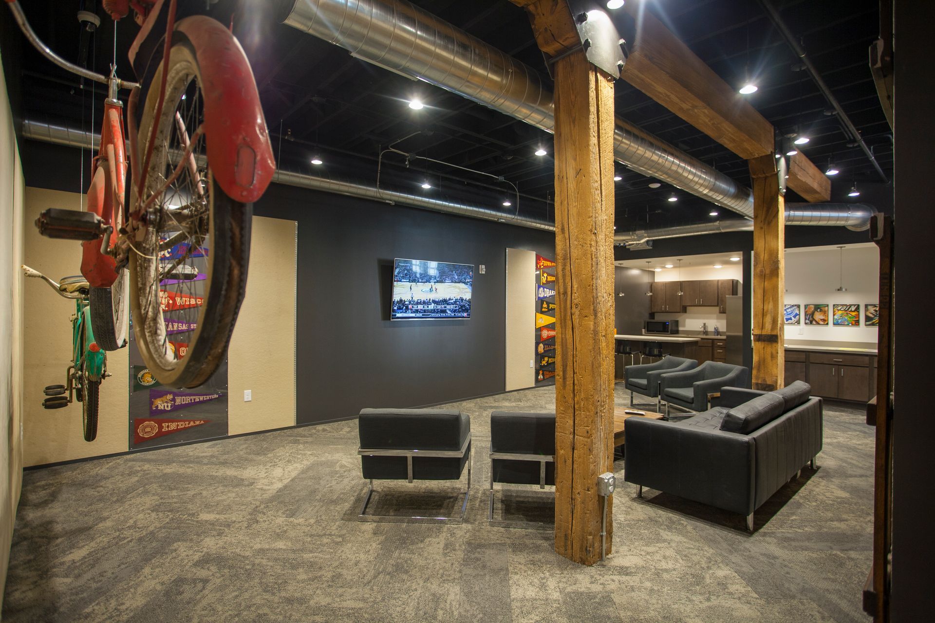 a living room with a motorcycle wheel hanging from the ceiling .