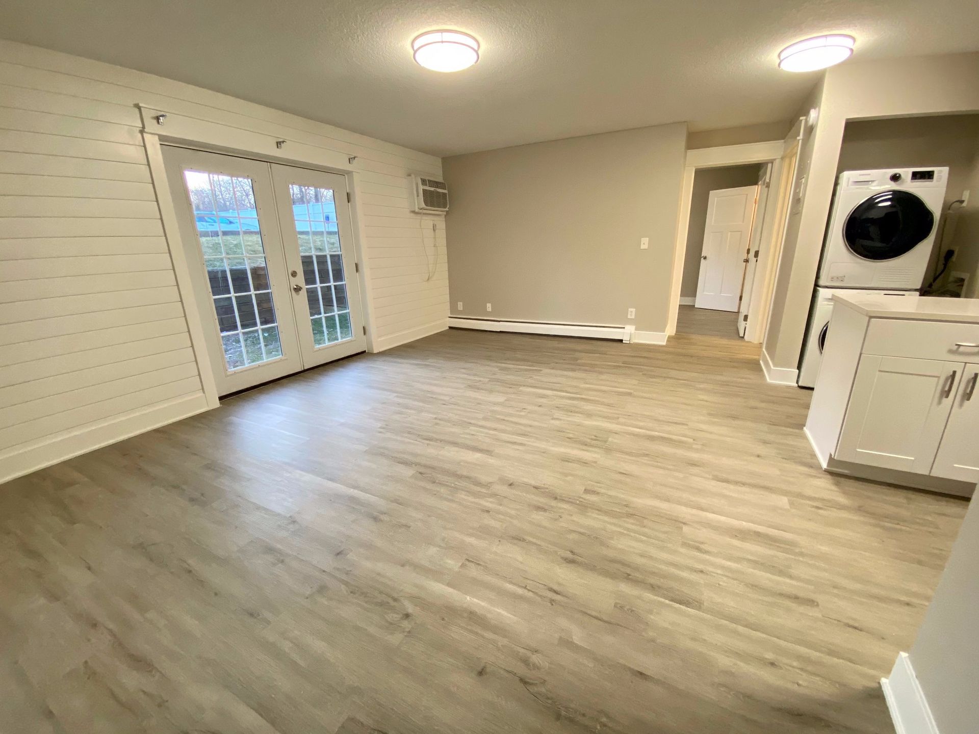 a living room with hardwood floors and a washer and dryer .