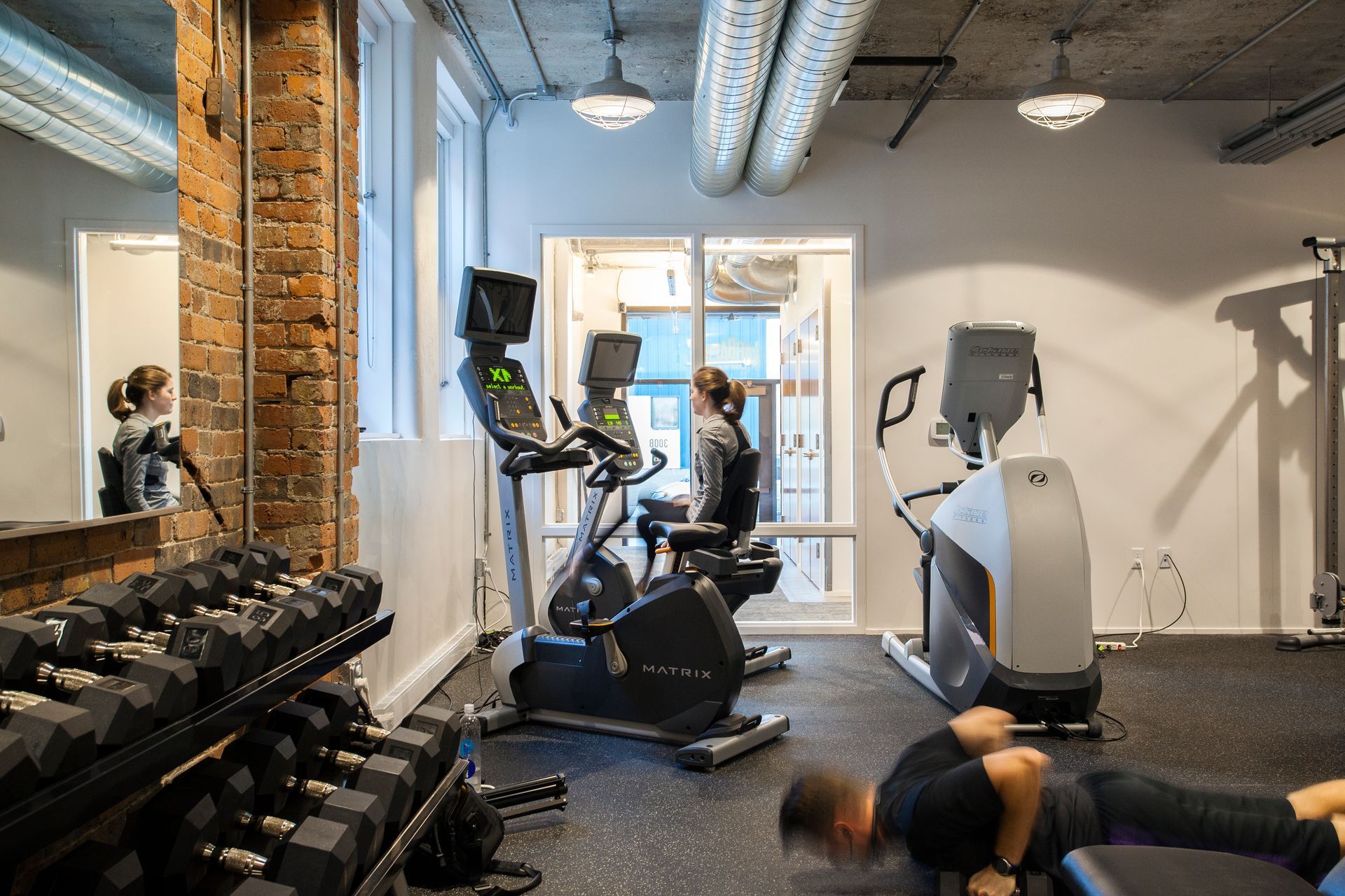 a man is doing push ups in a gym .