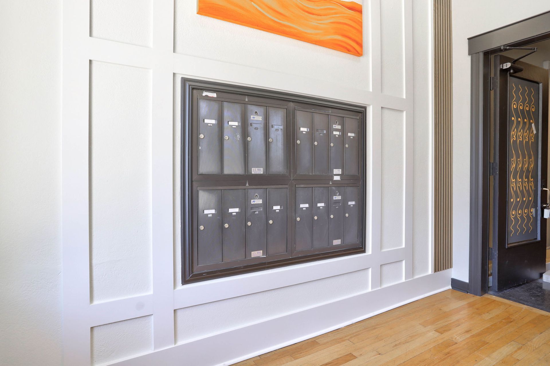 a wall with a bunch of mailboxes on it .