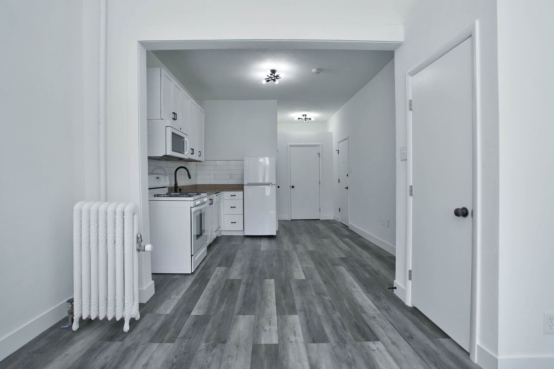 there is a radiator in the middle of the room in the kitchen .