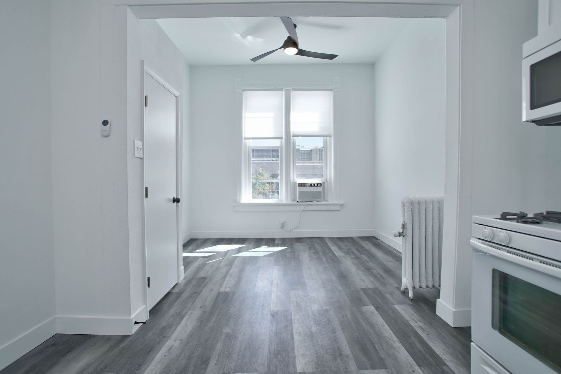 a kitchen with a stove and a ceiling fan .