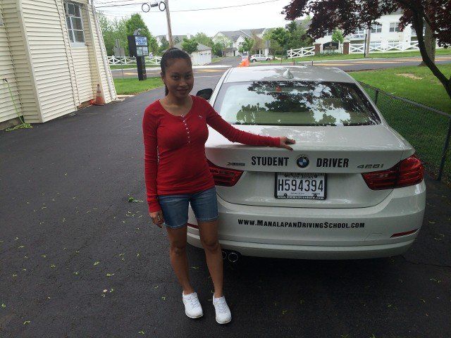 Student Practice — Girl Standing Behind BMW Car in Freehold, NJ