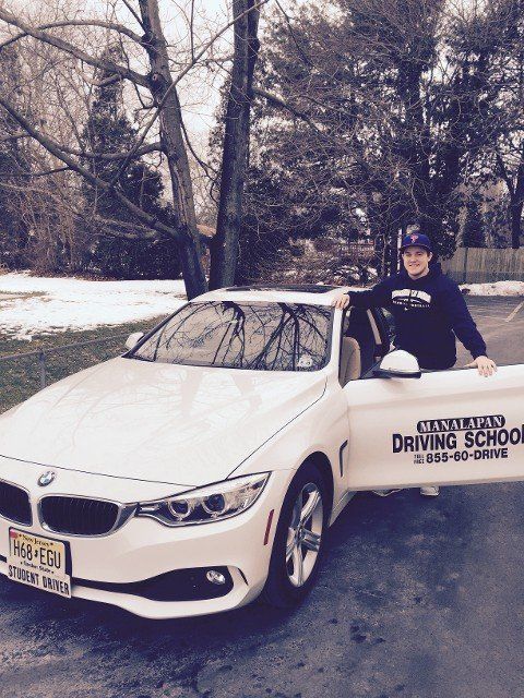 Driving Class And Lesson — Man Standing Beside White BMW Car in Freehold, NJ