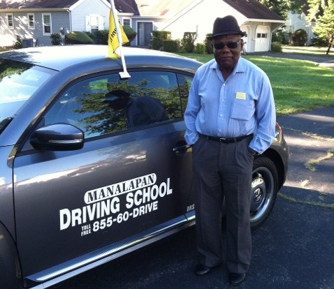 Driving School For Adults — Man Standing Beside Company Car in Freehold, NJ