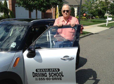 Driving Lessons — Man Standing Beside A Car in Freehold, NJ