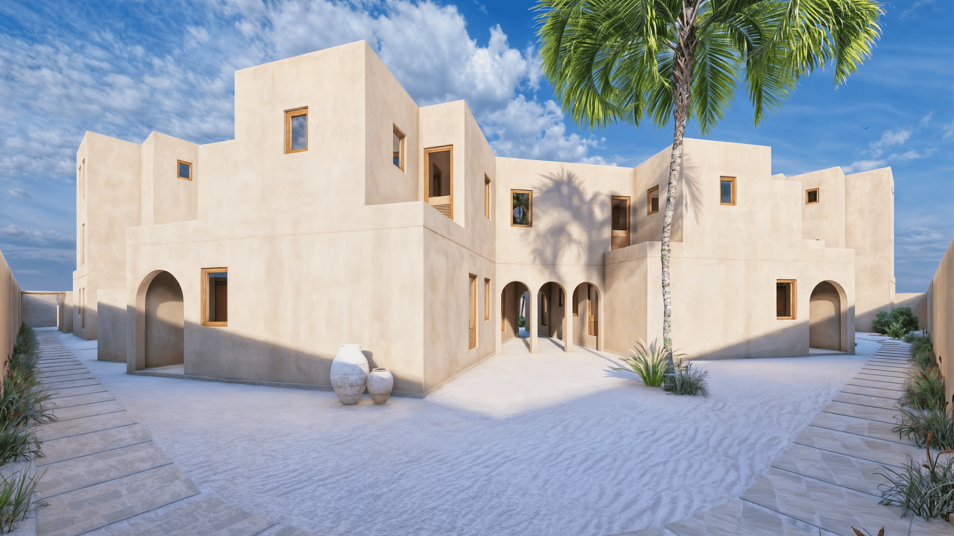 Exterior view of an elegant villa with white walls and wooden details, surrounded by tropical greenery.