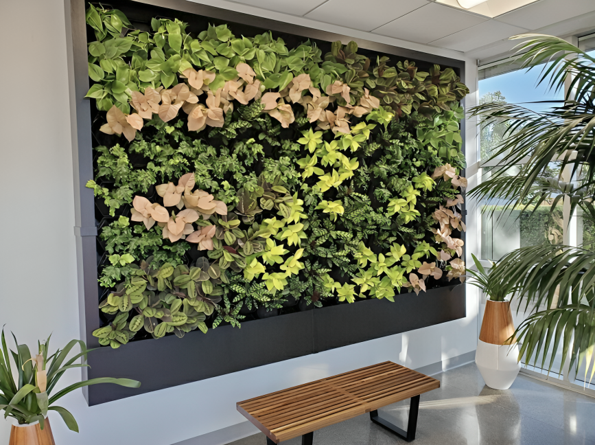 A living wall is hanging on a wall next to a bench.