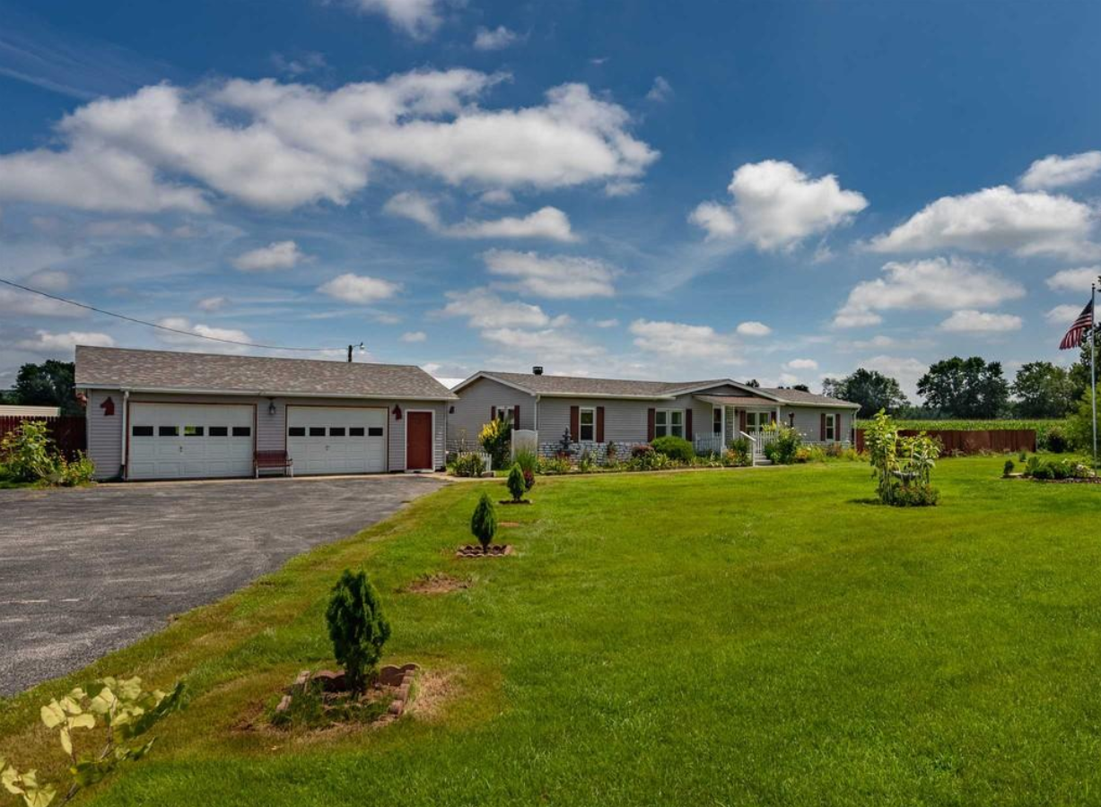 A large house with a large lawn in front of it.