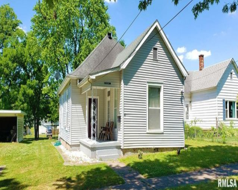 A small white house is for sale in illinois