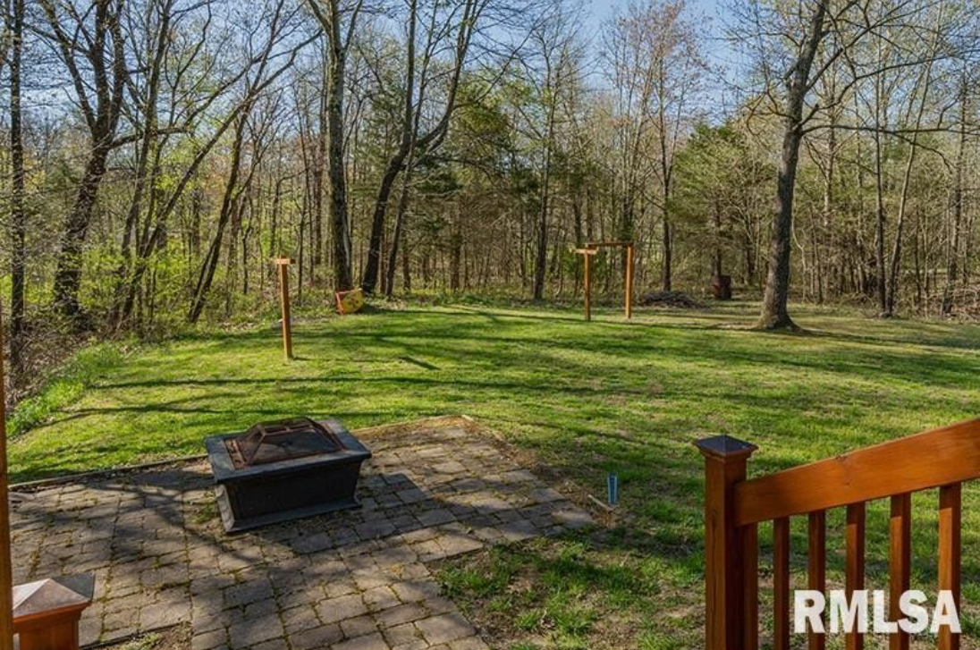 There is a fire pit in the middle of the yard.