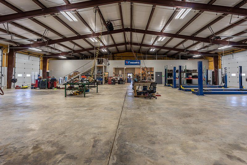 A large warehouse with a lot of machinery in it.