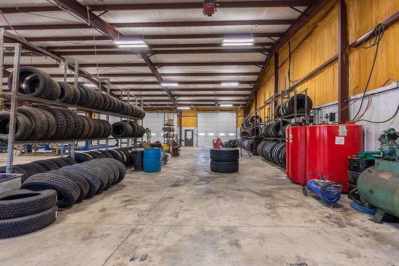 A large warehouse filled with lots of tires and machinery.