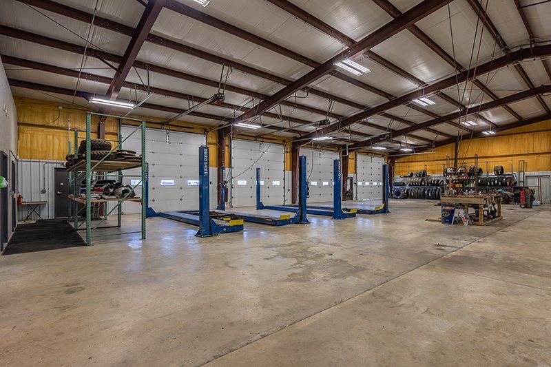 A large warehouse with a lot of lifts in it.