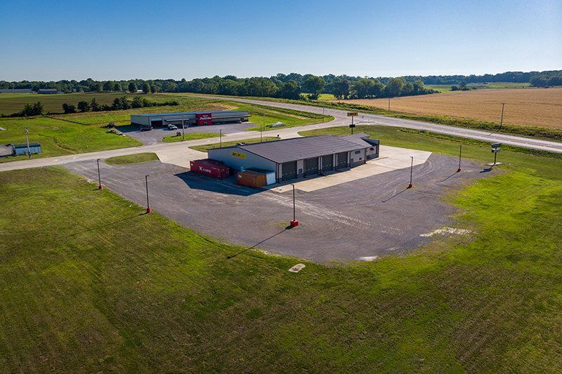 An aerial view of a building in the middle of a field.