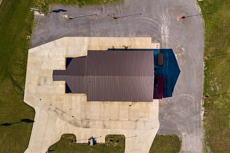 An aerial view of a large building in the middle of a field.