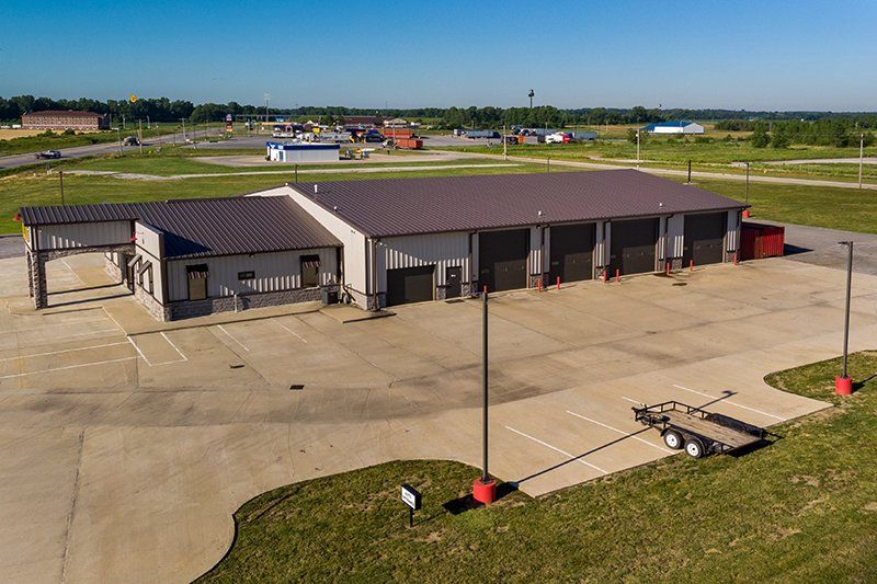 An aerial view of a large building with a trailer parked in front of it.