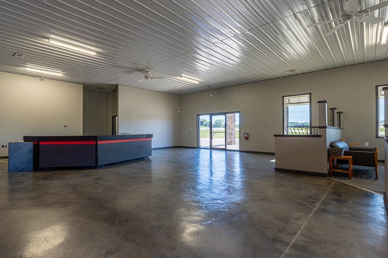 A large empty room with a counter in the middle of it.