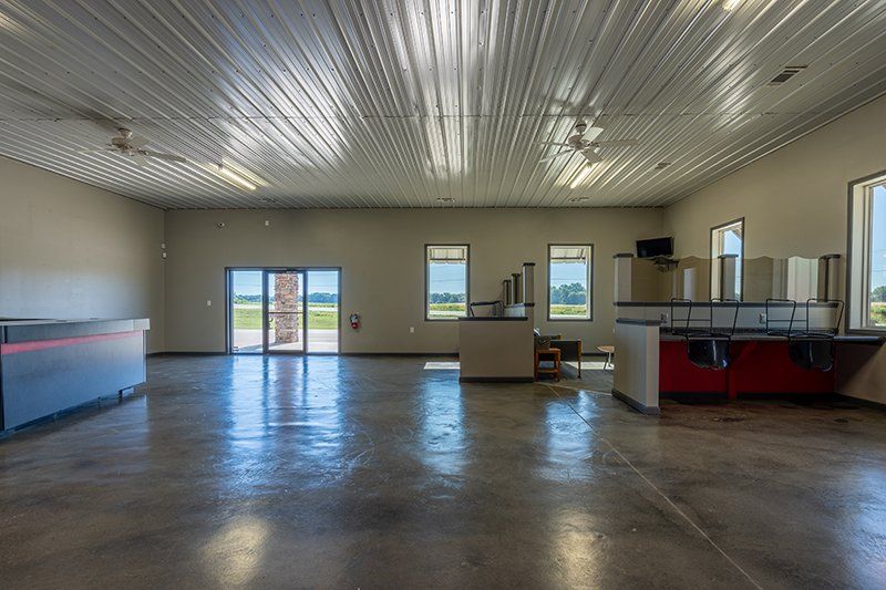 A large empty room with a metal ceiling and concrete floor.