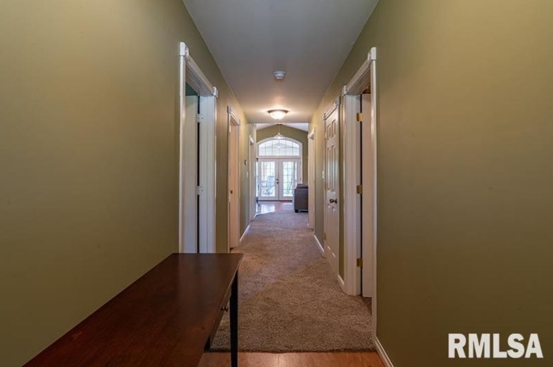 A long hallway in a house with rmlsa written on the bottom