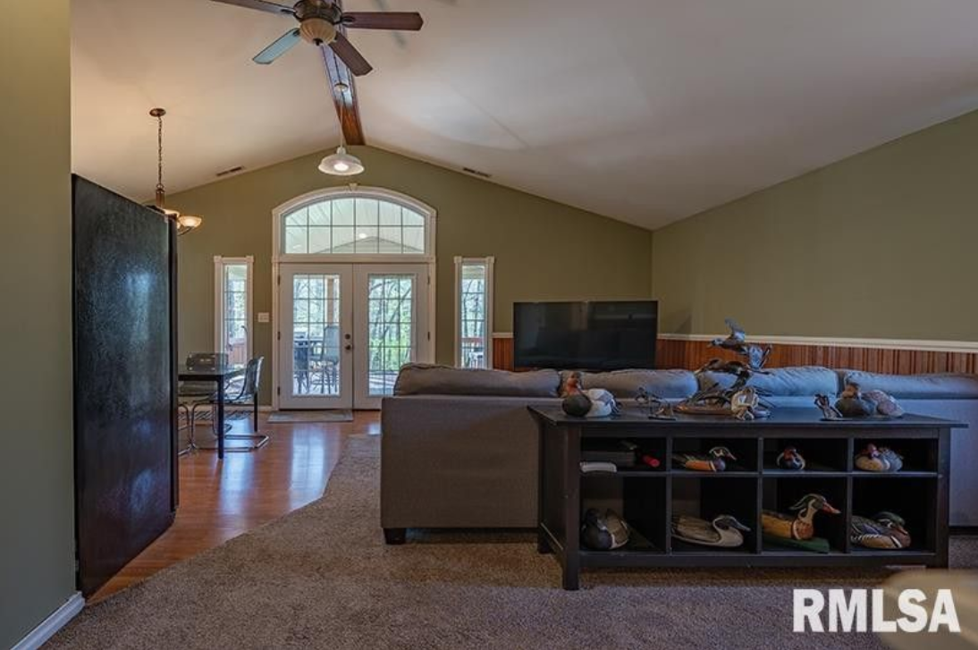 A living room with a ceiling fan and a couch.