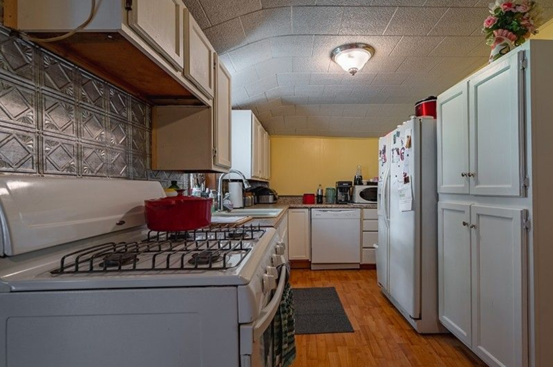 A kitchen with a stove , refrigerator and dishwasher.