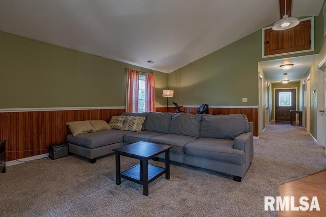 A living room with a sectional couch and a coffee table.