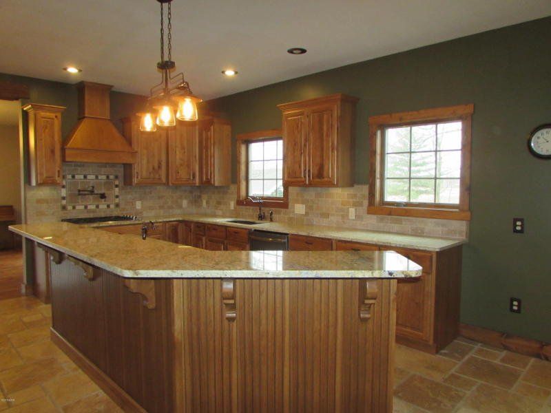 A kitchen with a large island and a clock on the wall