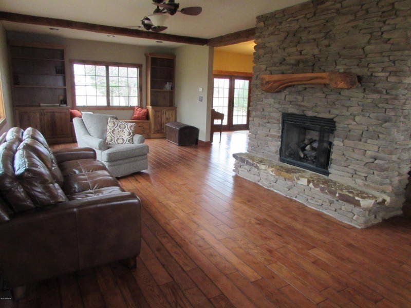 A living room with hardwood floors and a fireplace