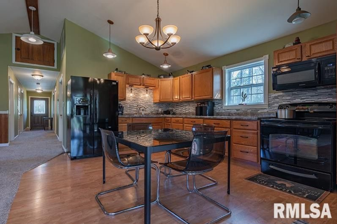 A kitchen with a table and chairs and the word rmlsa on the bottom