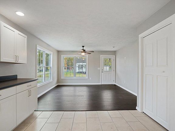 There is a ceiling fan in the living room and a kitchen.